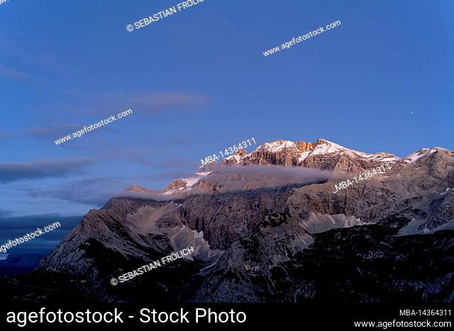 The Birkkarspitze in the Karwendel and the Karwendelhaus shortly after sunset with light clouds