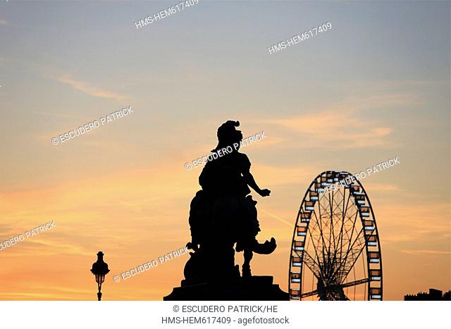 France, Paris, the Equestrian statue of Louis XIV in Cour napoleon of the Louvre museum and the Great Wheel in the Jardin des Tuileries Tuileries Gardens