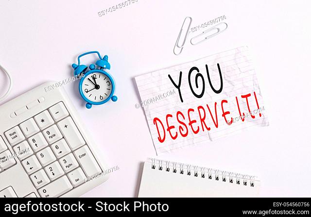 Writing note showing You Deserve It. Business concept for should have it because of their qualities or actions Blank paper with copy space on the table with...