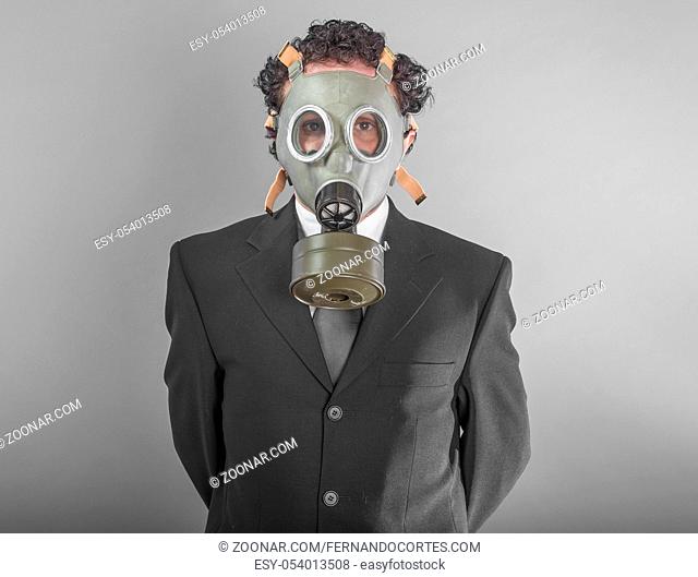 Businessman with mask, concept business dangerous for the environment or for society