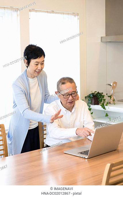 Senior couple enjoying video chatting on laptop