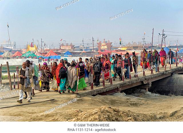 Pilgrims crossing the Ganges river on a temporary pontoon bridge, Allahabad Kumbh Mela, Allahabad, Uttar Pradesh, India, Asia
