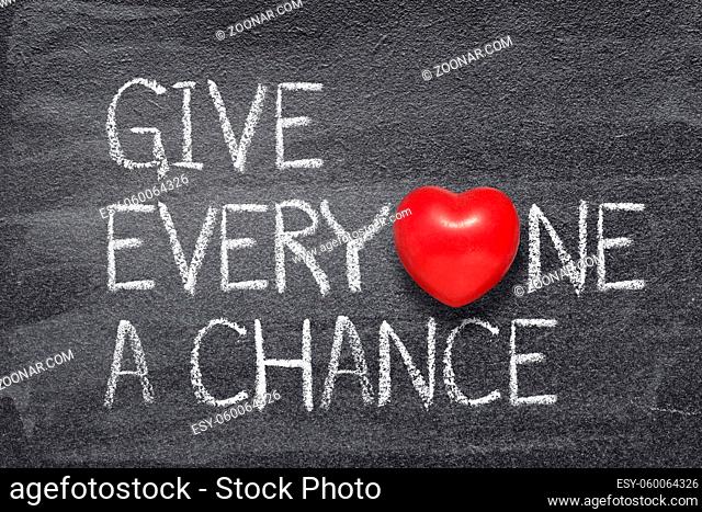 give everyone a chance phrase written on chalkboard with red heart symbol