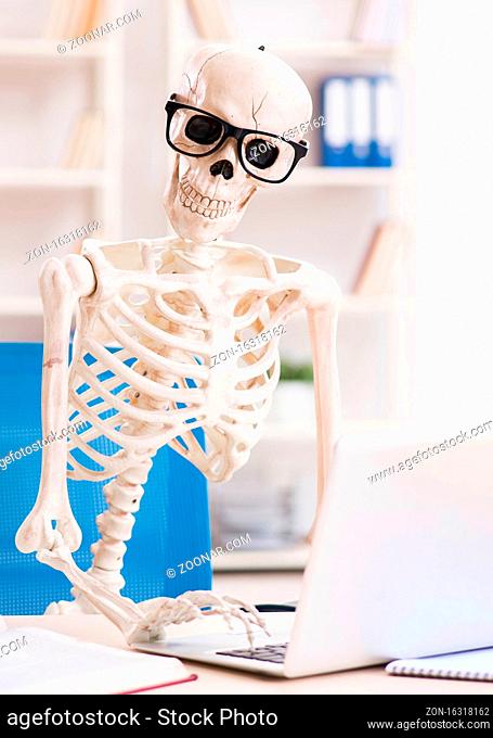 The skeleton businessman working in the office