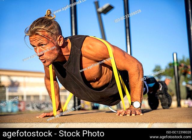 Spain, Mallorca, Man exercising at outdoor gym