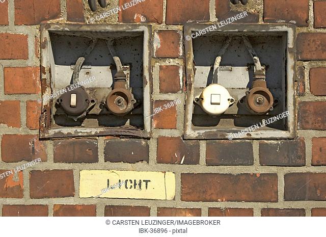 Very old light switches at a wall