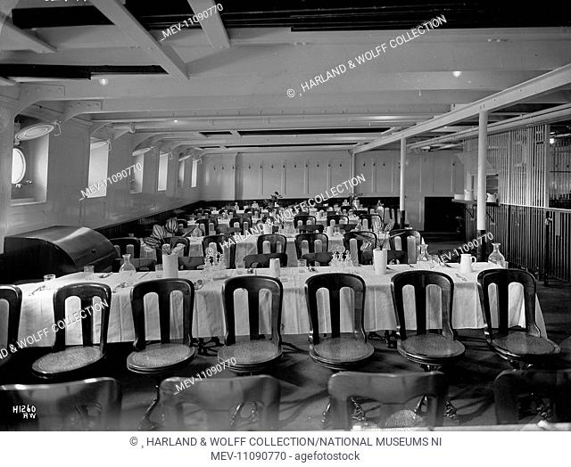 Third class dining saloon, with tables laid and decorated with plants. Ship No: 392. Name: Pericles. Type: Passenger Ship. Tonnage: 10924