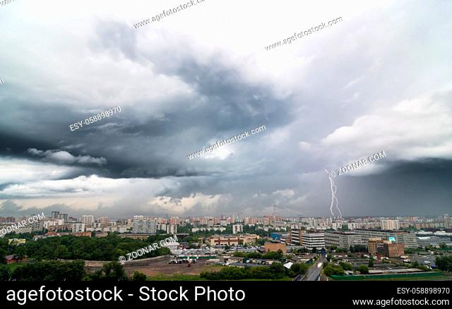 Lightning bolt over city in stormy day. Moscow, Russia