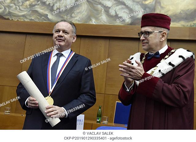 Andrej Kiska, president of the Slovak Republic, receives a Great gold medal of Masaryk University from (MUNI) Rector Mikulas Bek (right) during the ceremony...