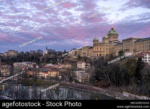 Switzerland, Canton of Bern, Bern, Aare river canal and Federal Palace at autumn dusk