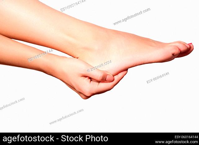 Closeup view of a young woman with pain on leg on white background