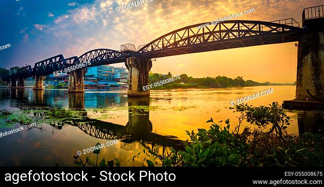 The bridge on the river Kwai at sunrise. Beautiful view of Railway. Touristic attraction in Kanchanaburi, Thailand. Panorama