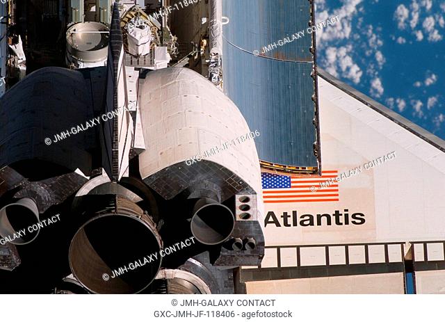 A crewmember aboard the International Space Station took this picture with a handheld digital still camera as the Space Shuttle Atlantis performed a backflip...