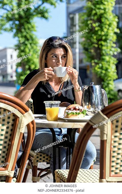Woman in outdoor cafe