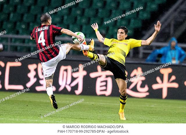 Milan's Jose Mauri (l) and Dortmund's Marc Bartra in action during the international club friendly soccer match between AC Milan and Borussia Dortmund in...