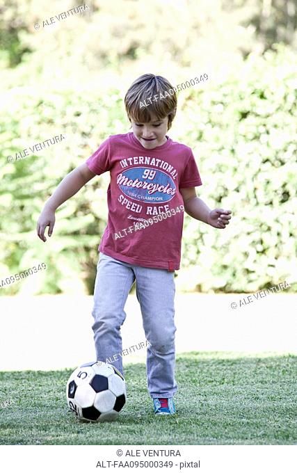 Boy kicking soccer