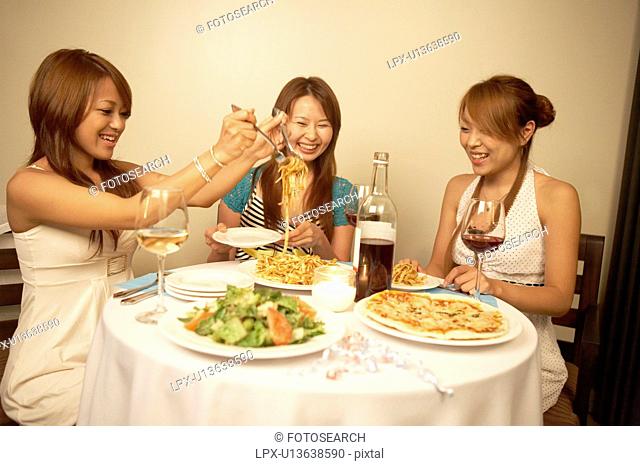 Young women eating dinner