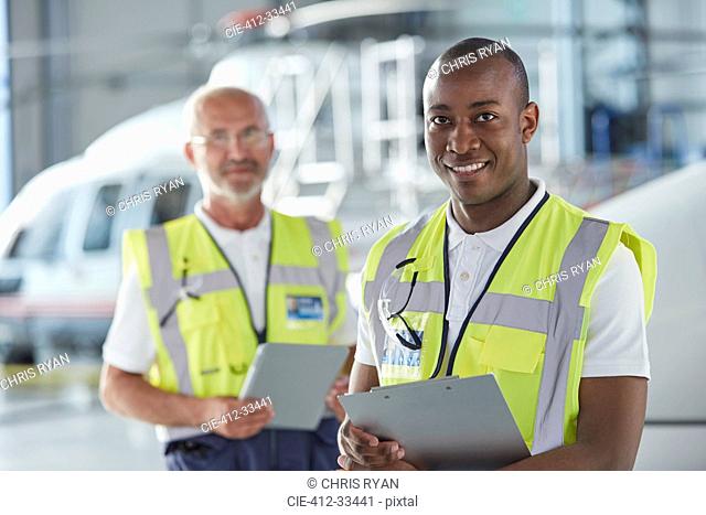 Portrait smiling air traffic control ground crew worker with clipboard