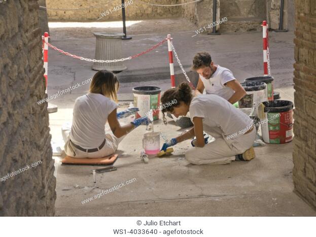 Workers doing restoration of Pompeii archaelogical site near Naples, Italy