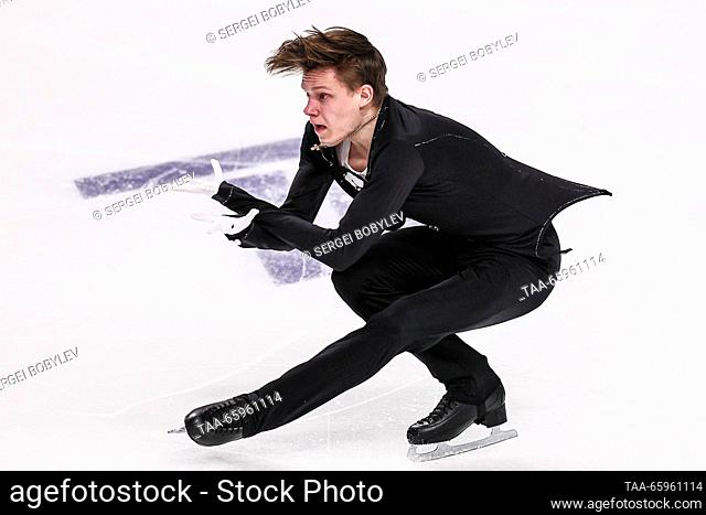 RUSSIA, CHELYABINSK - DECEMBER 21, 2023: Figure skater Yevgeny Semenenko performs a sit spin during his men's short programme as part of the 2024 Russian Figure...