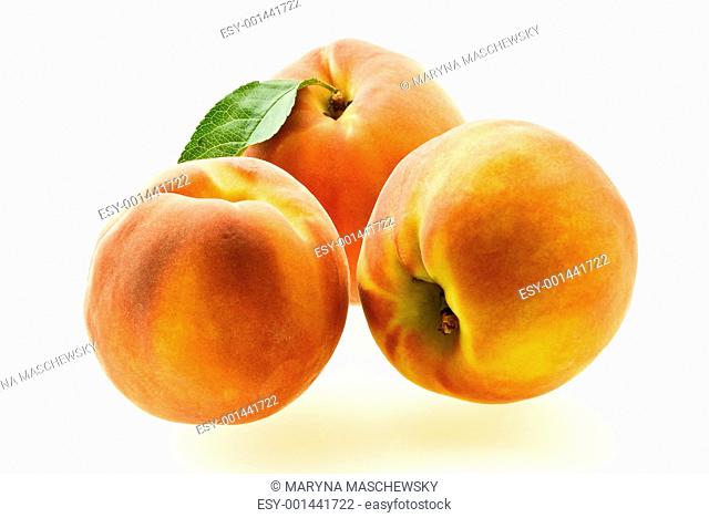 three ripe fresh peaches