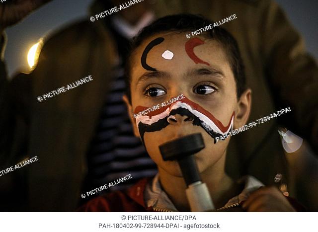 dpatop - A girl blows into a vuvuzela during celebrations after the re-election of Egyptian President Abdel-Fattah al-Sisi for a second four-year term