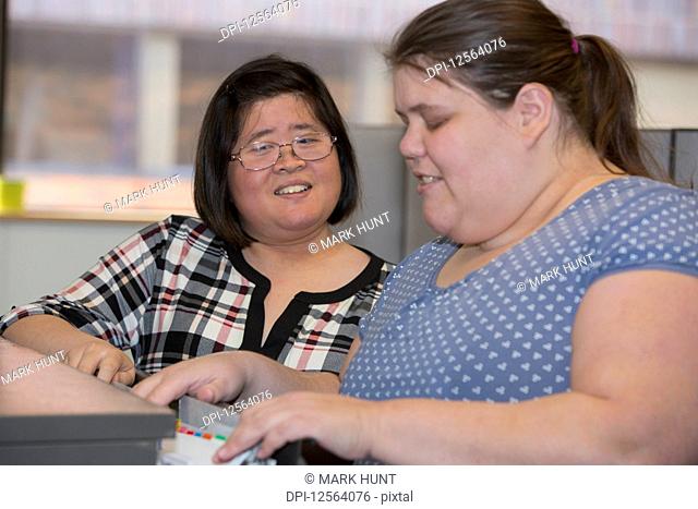 Two women with Learning Disabilities working in an office