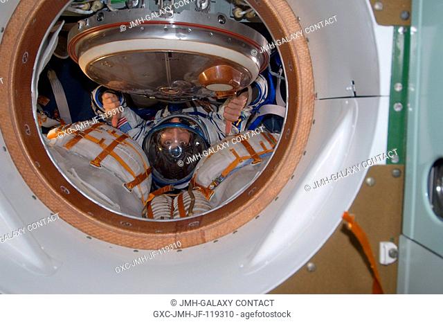 NASA astronaut Sunita Williams, Expedition 33 commander, attired in a Russian Sokol launch and entry suit, gives a thumbs-up while conducting a standard suit...