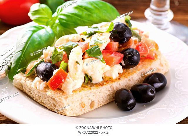 Bruschetta on focaccia with feta and olives
