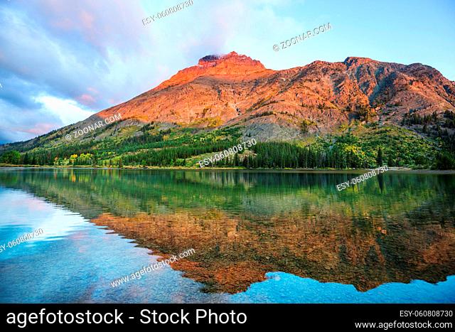 Serene scene by the mountain lake in Canada at sunset