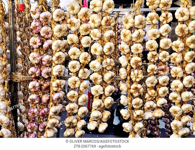 Garlic strings photographed during the "Feriona" in Boñar. Leon Province, Spain. This fair is held once a year for the local people to buy commodities for the...