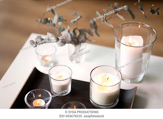 burning fragrance candles on table at cozy home