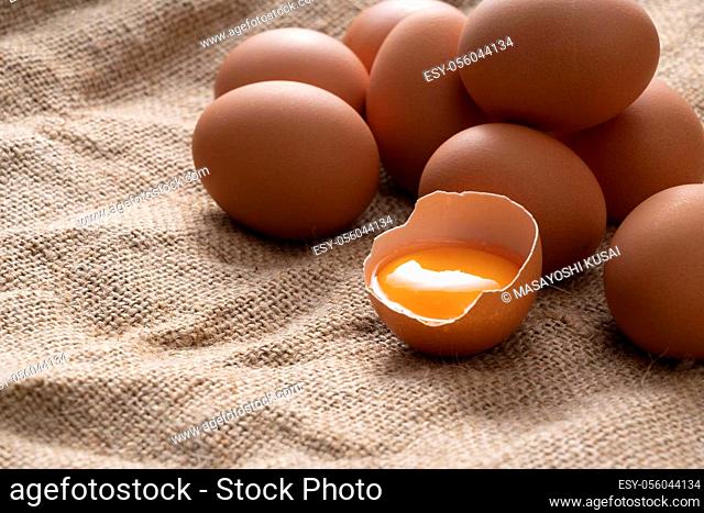 Eggs on the burlap and broken eggs are photographed from an angle