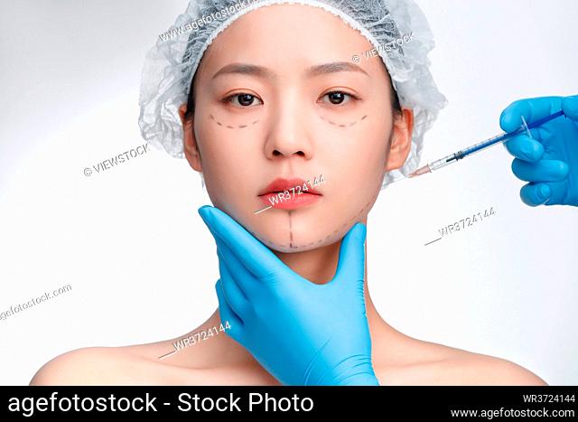Young woman do facial injections