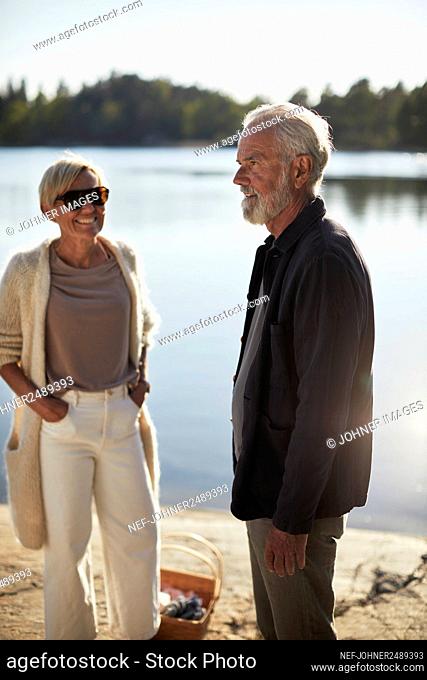 Smiling couple standing at lake