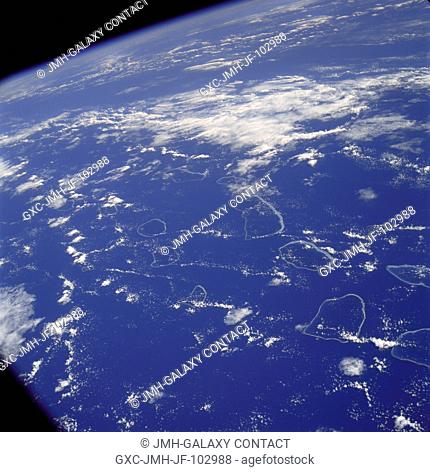 Tuamotu Archipelago in the South Pacific Ocean, looking southwest, as photographed from the Apollo 7 spacecraft during its 141st revolution of Earth