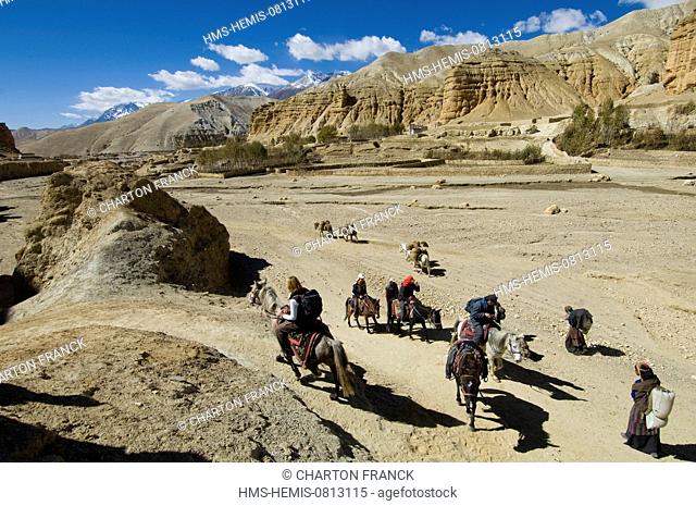 Nepal, Dhawalagiri Zone, Mustang District (former Kingdom of Lo), Niphuk, canyon and ancient troglodytic town, horse riders