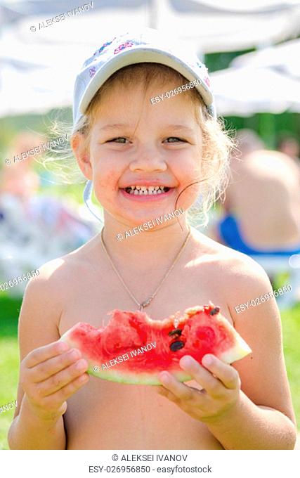 Funny cheerful girl eating watermelon, close-up portrait