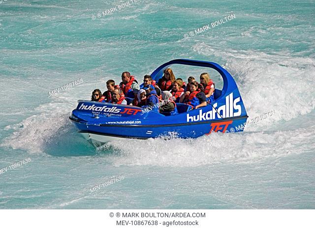 Tourists in Huka Falls jet boat Waikato River. Taupo North Island New Zealand