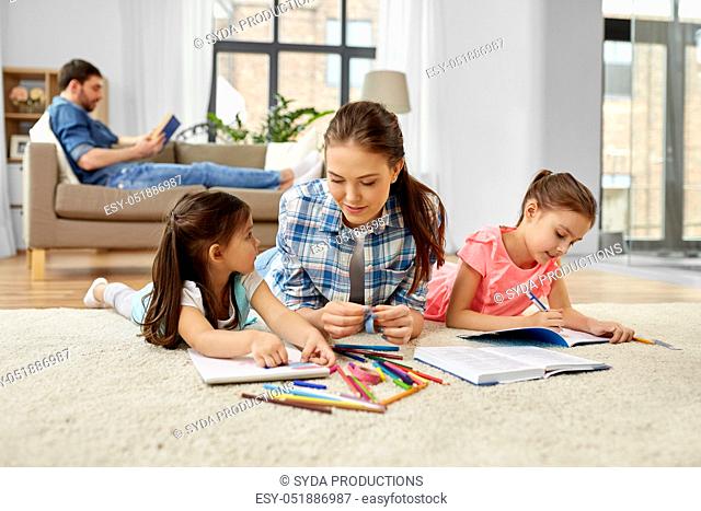 mother spending time with little daughters at home