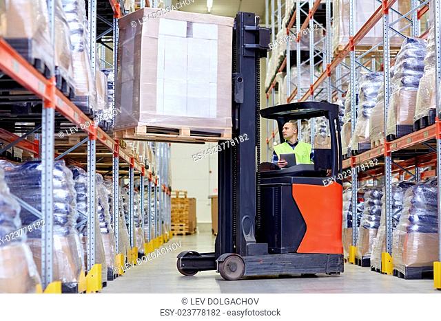 wholesale, logistic, loading, shipment and people concept - man or loader with tablet pc computer and forklift or loader loading boxes at warehouse