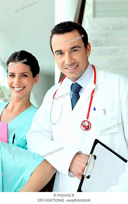 Cheerful doctor with practical nurse