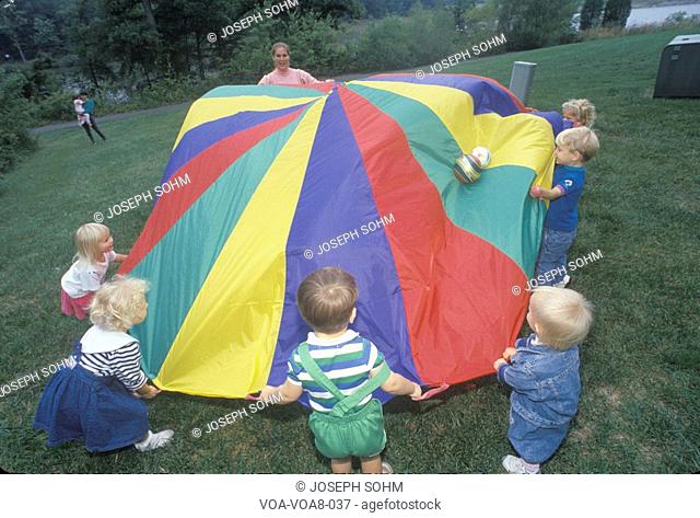 Daycare children playing a parachute game