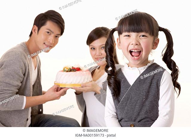 Young family celebrating birthday with smile together