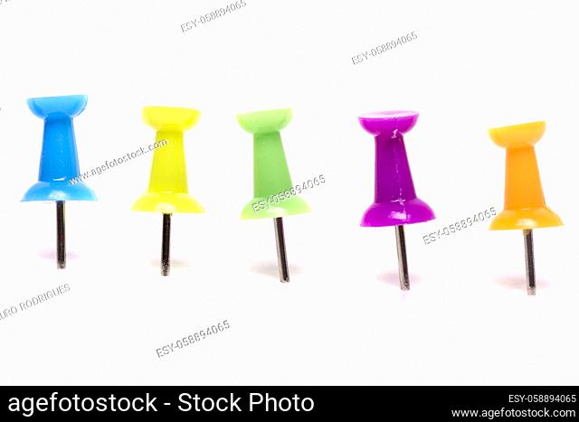 View of a horizontal line of pinned colorful push pins isolated on a white background