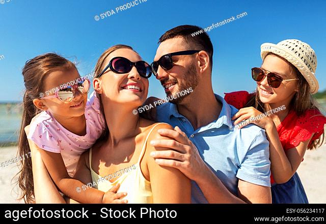 happy family in sunglasses on summer beach