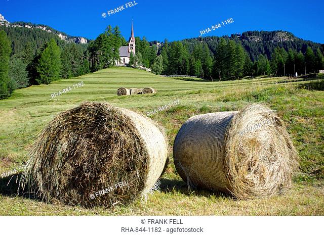 Church and hay bales, Vigo di Fassa, Fassa Valley, Trento Province, Trentino-Alto Adige/South Tyrol, Italian Dolomites, Italy, Europe