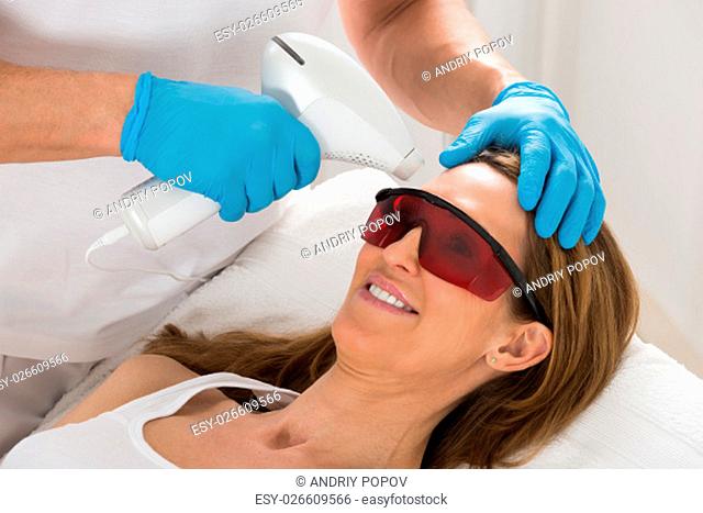 Mature Woman Receive Laser Epilation In Beauty Clinic