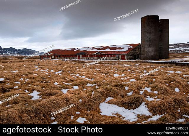 Abandoned factory on the fileds covered with moss and snow in Iceland