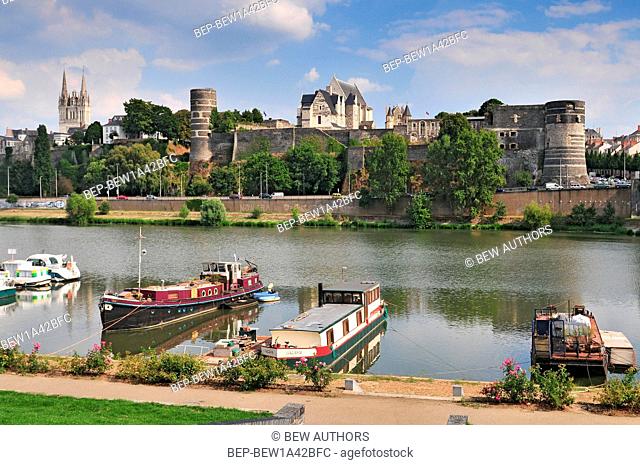 Port on the Maine river of Angers and the cathedral Saint Maurice at the top of hill western France